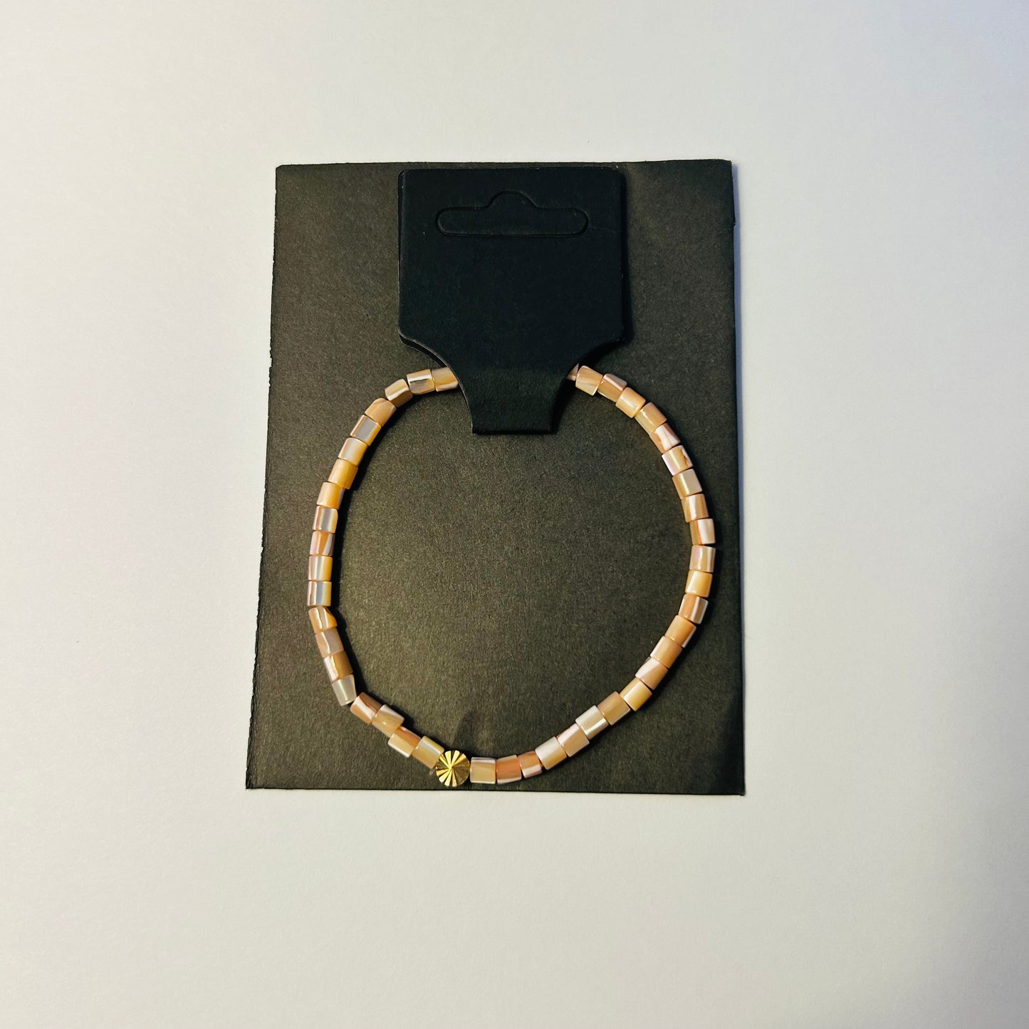 Bracelet on a black card with a white background