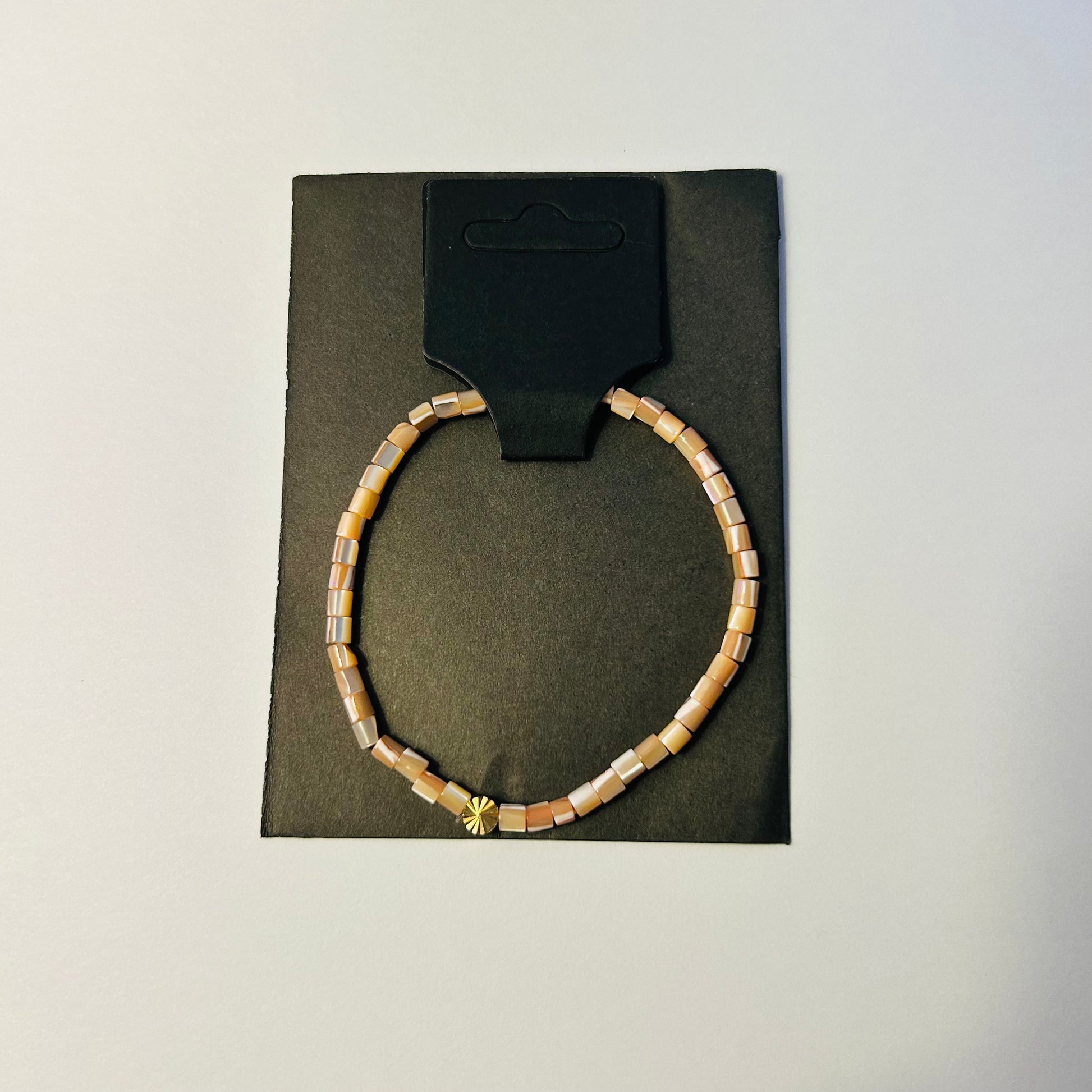 Bracelet on a black card with a white background