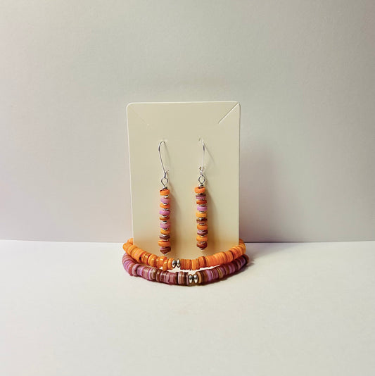 Beaded earrings and bracelet on a display card with a plain background